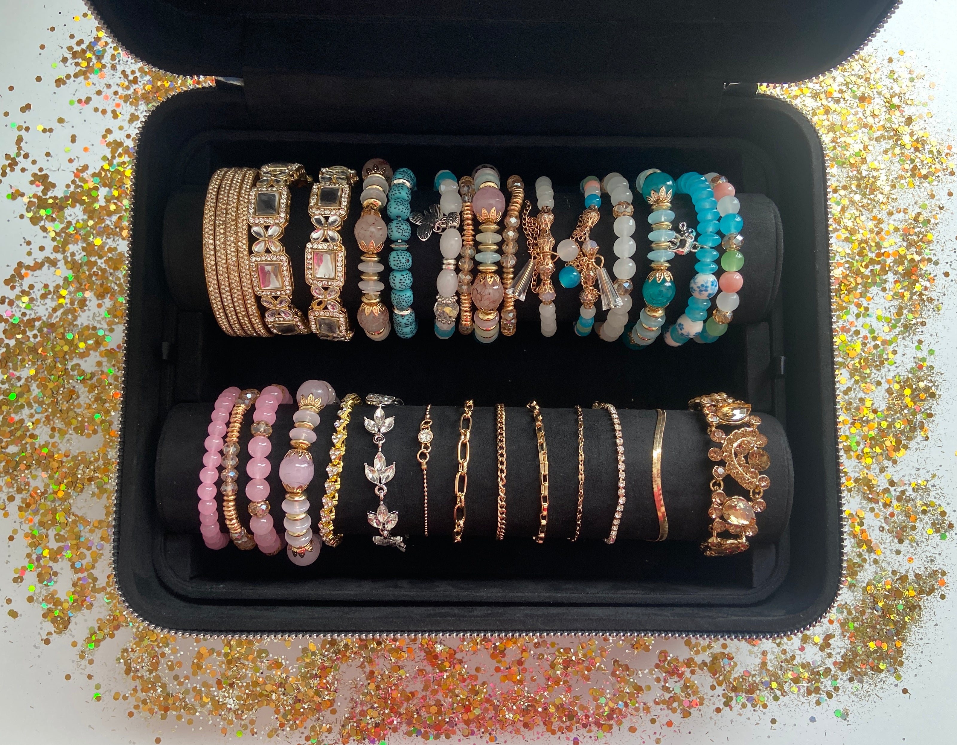Black jewelry box with bracelets in a black case on a glittery surface