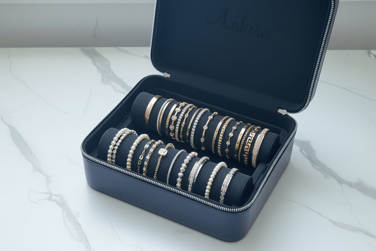 Set of bracelets in a black jewelry box on a marble surface, front side view